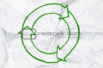 recycling symbol on white crumpled paper 