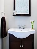 Black and white designer bathroom with mirror and flower