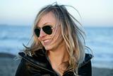 Blond girl with sunglasses on the beach