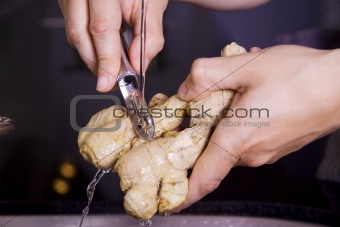 Man peeling a ginger fruit