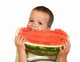 Happy boy eating watermelon