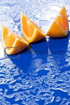 Orange slices on blue surface