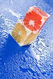 Citrus cubes on wet surface