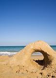 Empty beach with sand castle