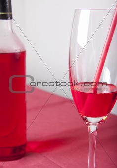 Red cocktail and bottle