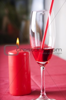 Red cocktail and candle