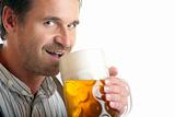Bavarian man drinks out of Oktoberfest beer stein