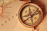 Antique brass compass over old USA map