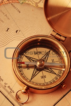 Antique brass compass over old USA map