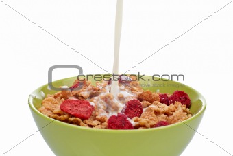 Cornflakes with milk being poured