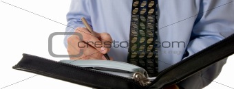 Business man writing in leather organizer