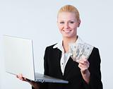 Woman holding dollars and a laptop