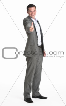 Young businessman making a thumbs up gesture