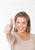 Young woman with headset giving a thumbs-up