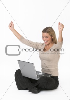 Young woman with laptop cheering