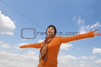 Smiling female posing with outstretched arms