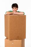 Brunette posing while resting her arms on a cardboard box