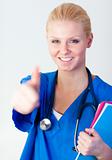 Doctor with her thumb up with focus on face