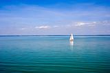 Blue landscape with sailboat