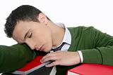 boy student sleeping over stack books over desk