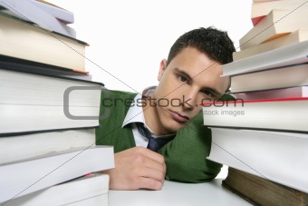 Young unhappy student with stacked books