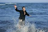Man running happy on the blue summer beach