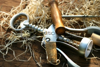 Cork screws laying on oak table 
