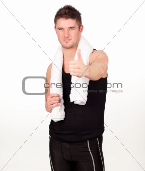 Sporting man with his thumbs up to the camera