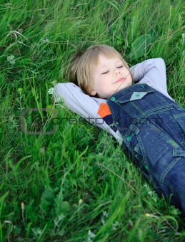 The boy on a green grass