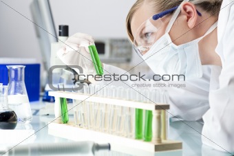Female Scientist or Doctor With Green Solution In Laboratory