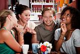 Man with three pretty women in coffee house