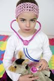 Little girl pretending to be doctor, stethoscope