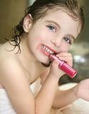 Little girl with lipstick on the bathroom