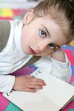 Beautiful preschooler girl studying book