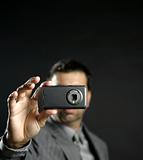 Businessman taking photos, mobile camera