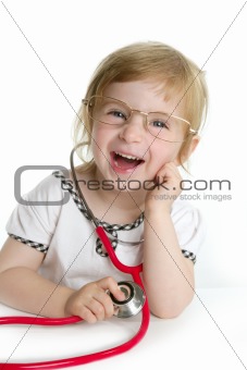 Cute little girl pretending to be a doctor
