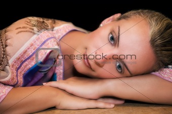 Beautiful woman resting on her arms and thinking