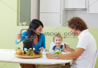 family eating meat fondue
