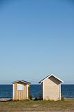 Two boathouses at the coastline