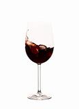 Red wine splashing in the glass