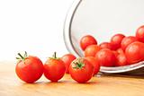 Washed Tomatoes in Colander on Cutting Board