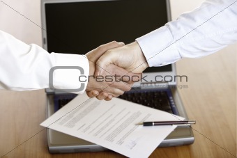 HANDSHAKE OF BUSINESSMAN AFTER SIGNING OF CONTRACT
