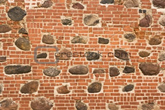 Brick wall with embedded stones 