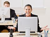 Businesswoman laughing at monitor