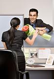 Businessman giving co-worker flowers
