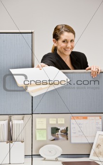 Businesswoman handing co-worker file folder