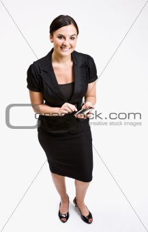 Businesswoman text messaging on cell phone