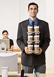 Businessman carrying tray of coffee