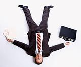 Businessman laying on floor and briefcase