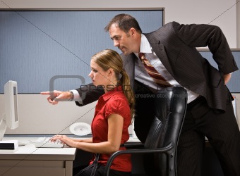 Businessman pointing at co-workers computer